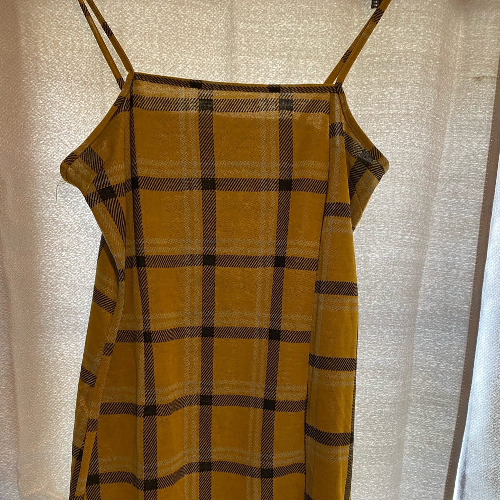 Medium sized mini plaid dress with slight slit at bottom.